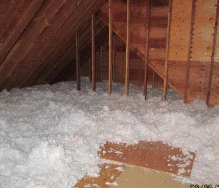 Photo of loose insulation piled up in attic