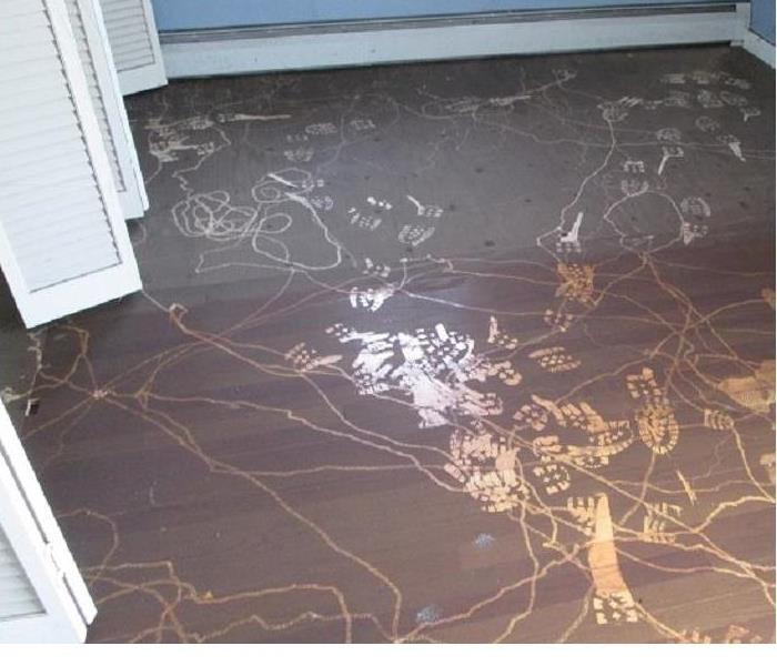 Photo of wood floor covered with soot