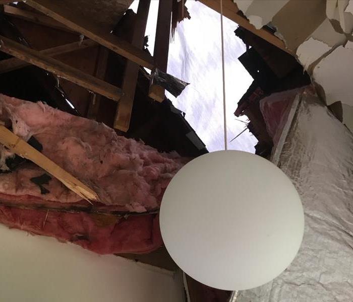 Photo of hole in roof after storm damage