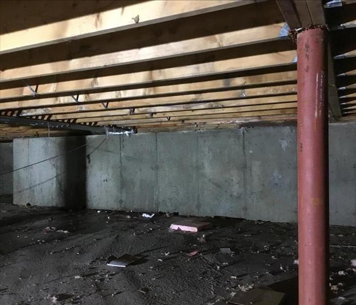 crawlspace with debris after water removal