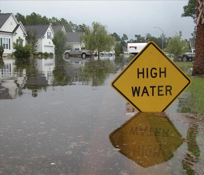 flooded street, high water sign