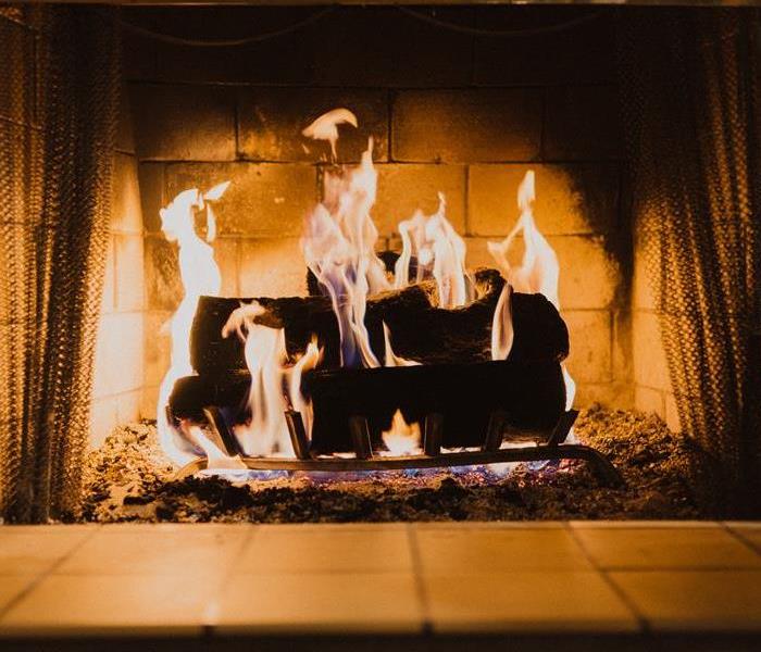 Photo of a fireplace with burning logs