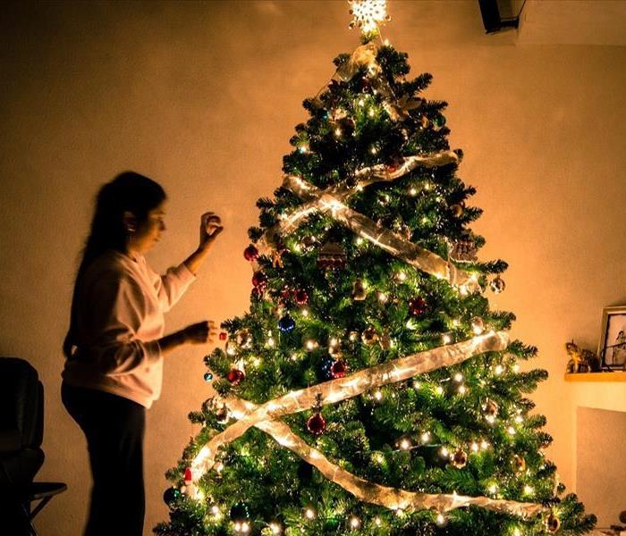 Photo of woman decorating Christmas Tree